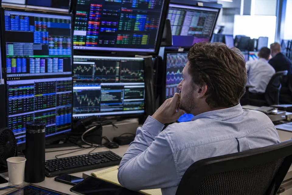 Sportsbook trading room with traders watching live data screens